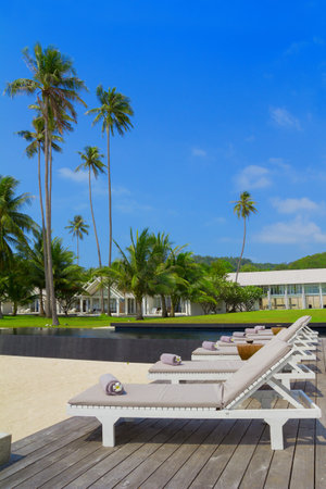 Spa beds with towels and flowers on tropical beach resortのeditorial素材
