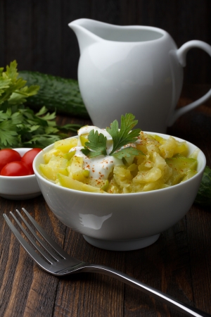 Bowl of prepared zucchini on wooden tableの写真素材