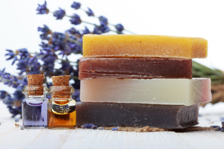 Handmade soap with lavender and essential oil on wooden table
