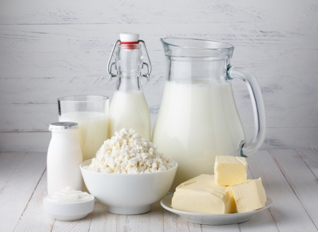Dairy products, milk, cottage cheese, yogurt, sour cream and butter on wooden tableの写真素材