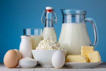 Dairy products, milk, cottage cheese, eggs, yogurt, sour cream and butter on wooden tableの写真素材