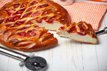 Strawberry pie with cutter and piece on cake lifterの写真素材
