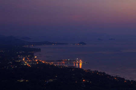 Small tropical city on ocean beach at twilight, long exposureの写真素材