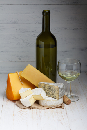 White wine and cheese on wooden tableの写真素材