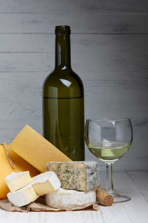 White wine and cheese on wooden tableの写真素材