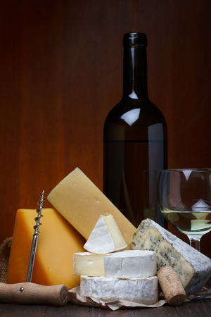 Cheese assortment and wine on wooden table still lifeの写真素材