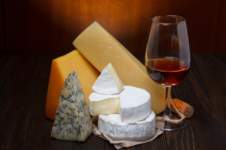 Red wine and cheese assortment on wooden tableの写真素材