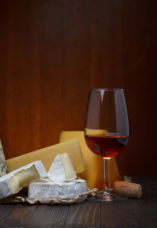 Red wine and cheese assortment on wooden tableの写真素材