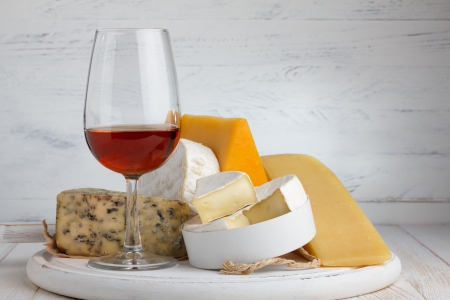 Cheese and red wine on wooden table still lifeの写真素材