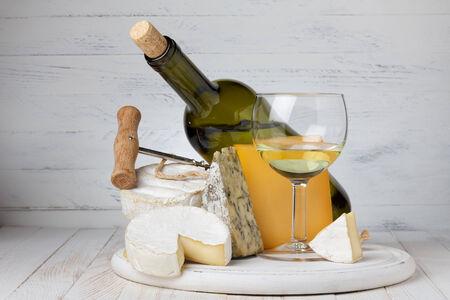 Cheese and wine on wooden table still lifeの写真素材