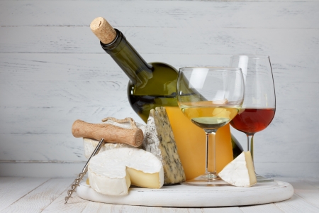 Cheese and wine on wooden table still lifeの写真素材