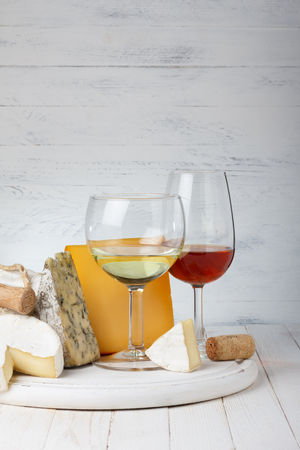Cheese and wine on wooden tableの写真素材