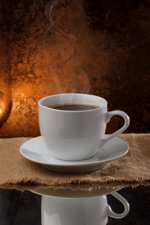 Cup of hot coffee with steamの写真素材