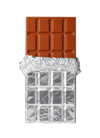 Milk chocolate bar in silver foil, half opened, isolated on whiteの写真素材