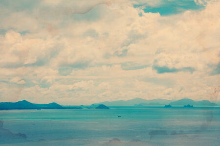 Vintage stylized tropical ocean with islands on horizonの写真素材