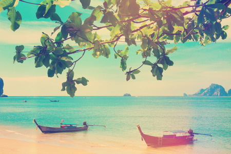 Vintage stylized photo of traditional longtail boats at Andaman sea, Thailandの写真素材
