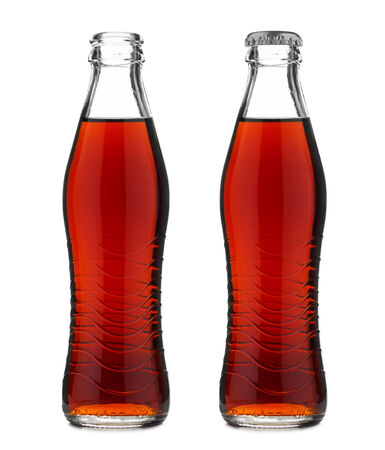 Open and closed glass bottle with soft drink cola or soda isolated on whiteの写真素材