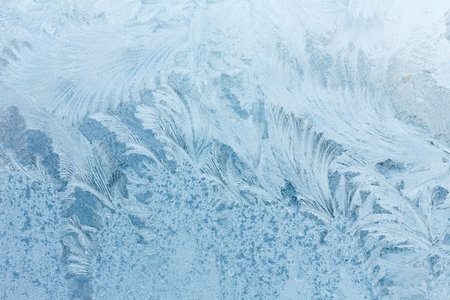 Frosty ice pattern on winter window glass