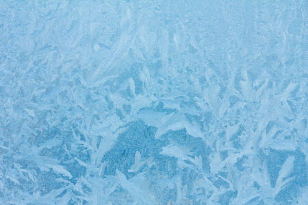 Frosty ice pattern on winter window glassの写真素材