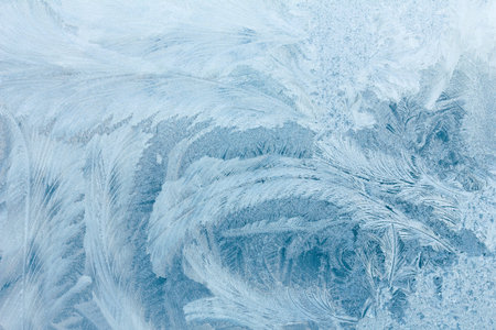 Frosty ice pattern on winter window glass