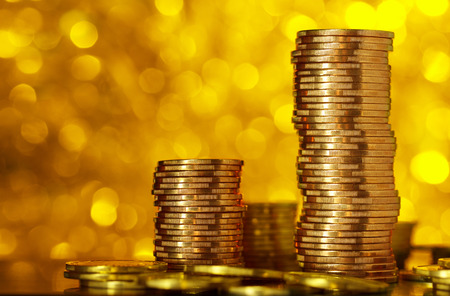 Coins stack on golden bokeh の写真素材