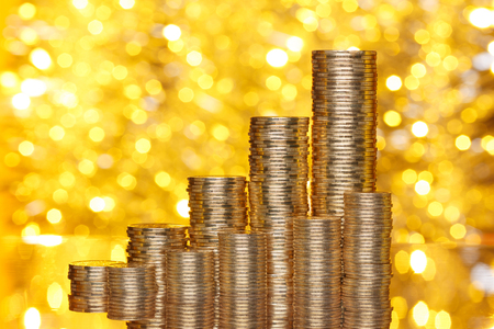 Golden coins stack on bokeh の写真素材