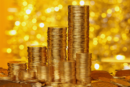Coins stack on golden bokeh の写真素材