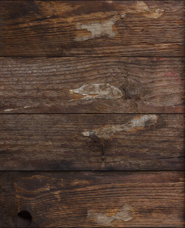 Grunge dark wood with pieces glued paper on itの写真素材