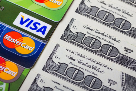 KIEV, UKRAINE - March 22: Pile of credit cards, Visa and MasterCard, credit, debit and electronic with US dollar bills, in Kiev, Ukraine, on March 22, 2014.のeditorial素材