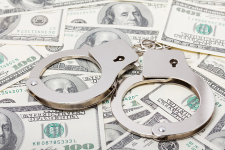 Handcuffs on moneyの写真素材