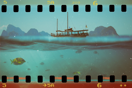 Tropical underwater shot splitted with ship and sky, vintage stylizedの写真素材