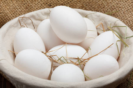 Eggs in a bowl on burlap clothの写真素材