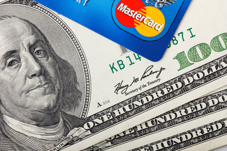 KIEV, UKRAINE - May 5: MasterCard credit card with US dollar bills, in Kiev, Ukraine, on May 5, 2014.のeditorial素材