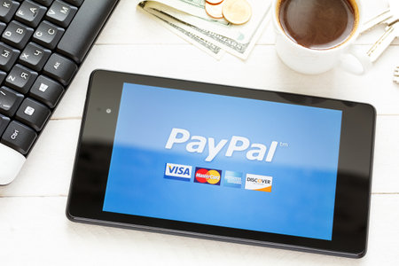 KIEV, UKRAINE - June 9: PayPal payment system logo on tablet, in Kiev, Ukraine, on June 9, 2014.のeditorial素材
