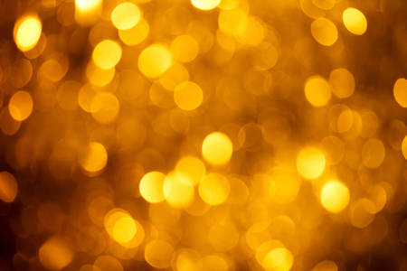 Blurred golden light sparks bokeh backgroundの写真素材