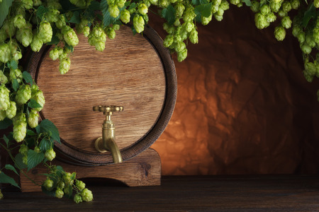 Beer barrel with fresh hops on wooden table still-lifeの写真素材