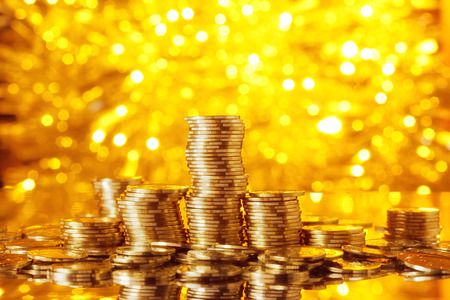 Golden goins stack with golden lights bokeh backgroundの写真素材
