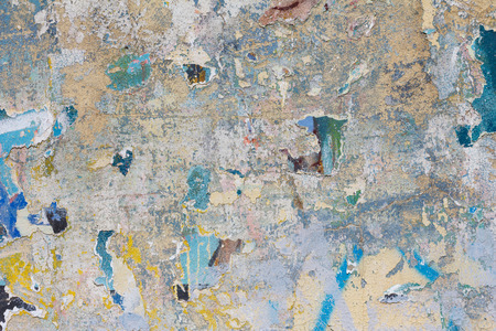 Grunge concrete wall with ripped posters and graffity textureの写真素材