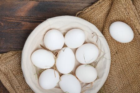 Eggs in a bowl on wooden table still lifeの写真素材