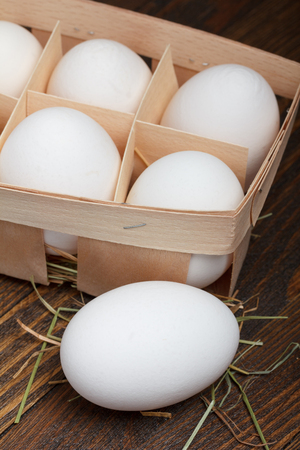 Eggs in a wooden box on wooden tableの写真素材