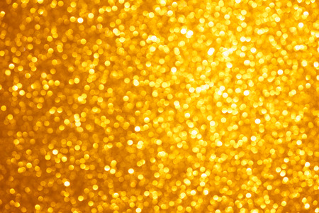 Golden lights bokeh background, abstract defocused glowing circlesの写真素材