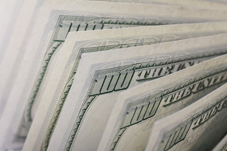 Hundred dollar bills in a row, back side, shallow depth of fieldの写真素材