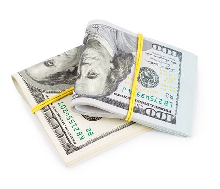 Hundred Dollar bills folded and tied with rubber band isolatedの写真素材