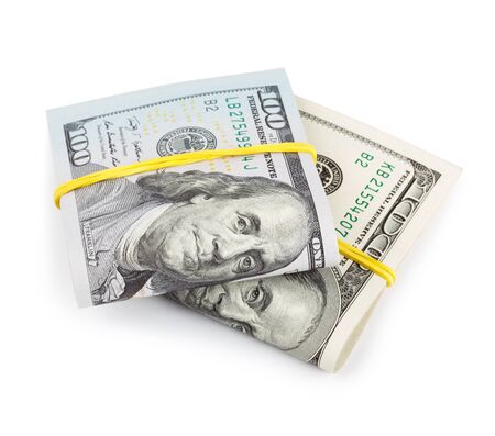100 Dollar bills folded and tied with rubber band isolatedの写真素材