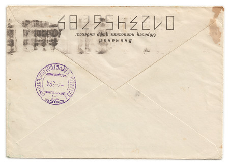 Grunge old envelope with meter stamp isolated on white backgroundの写真素材
