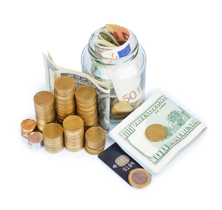 Coins stacks with paper currency and jar full or bills and coins with credit card isolated on whiteの写真素材