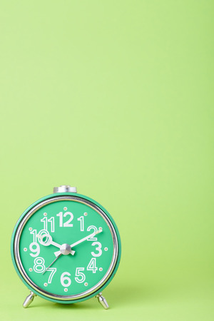 Retro old clock on green background with copy space for textの写真素材