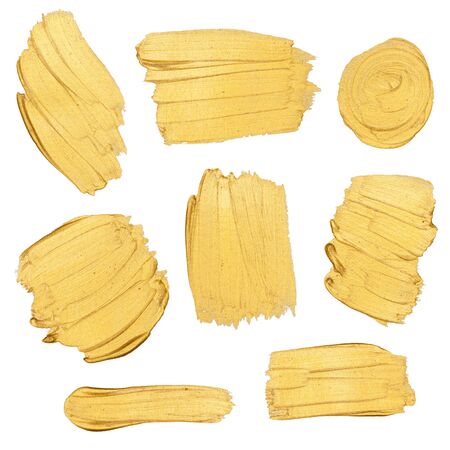 Gold paint stokes isolated on white backgroundの写真素材