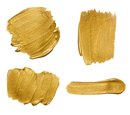 Gold paint stokes isolated on white backgroundの写真素材