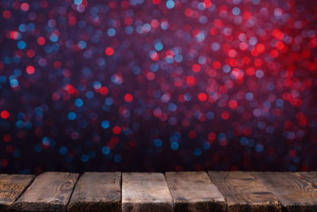 Old wooden table from weathered planks with glowing bokeh lights on backgroundの写真素材
